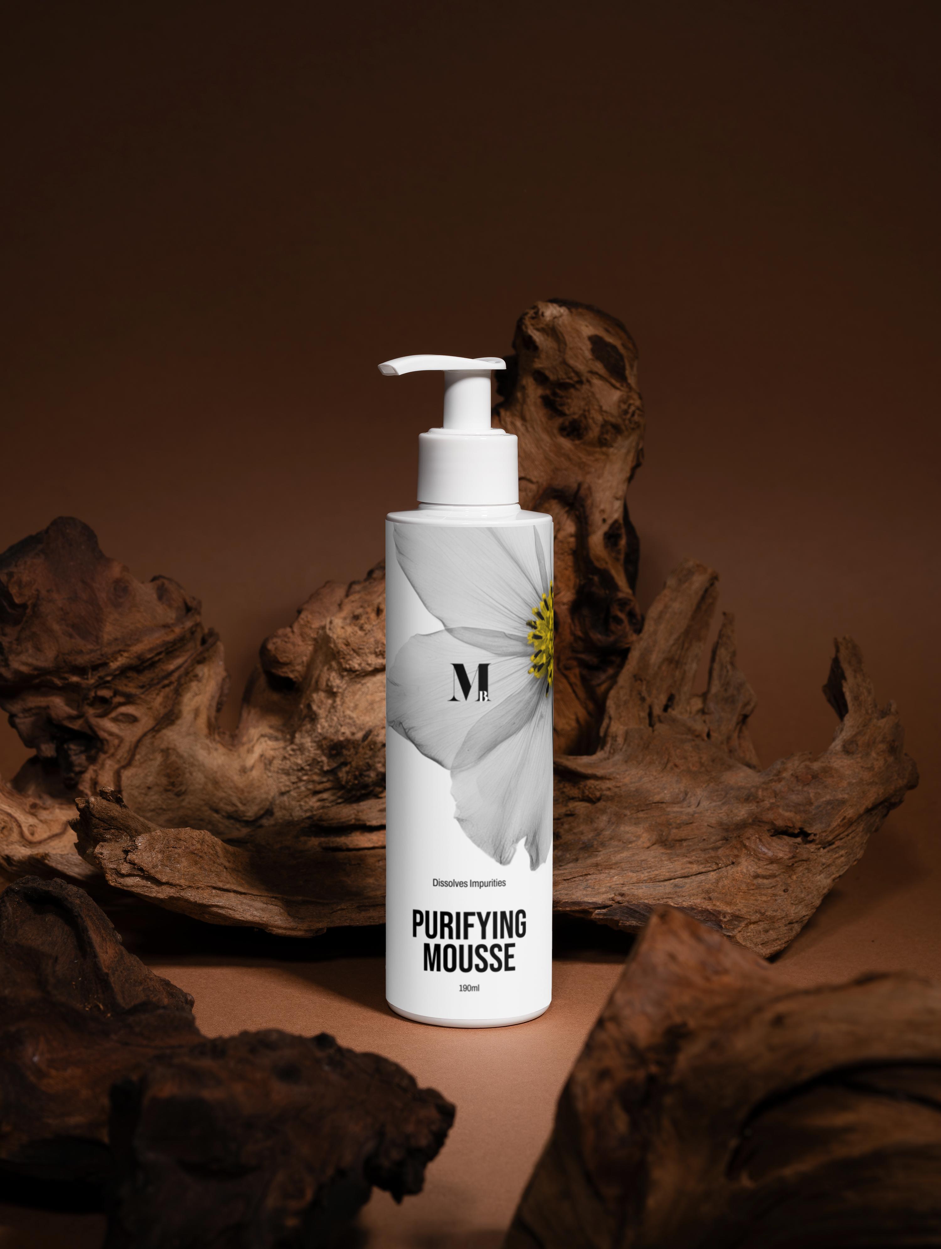 Purifying Mousse bottle with a white label against a brown background