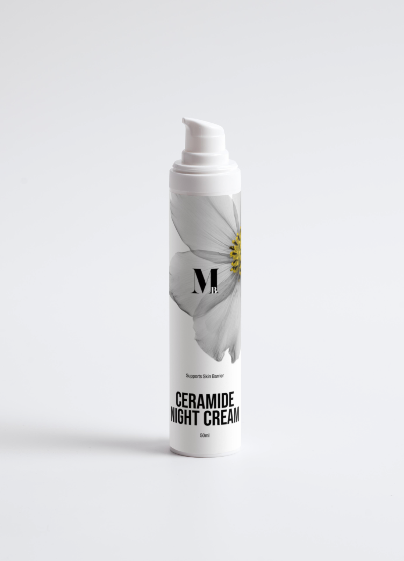 Ceramide night cream bottle with a white flower on a light gray background